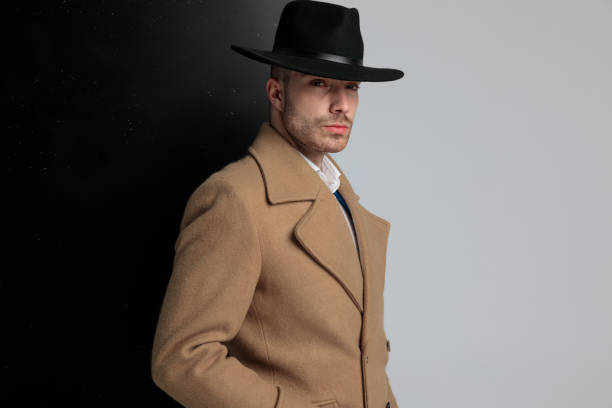 istock side view of confident young guy in longcoat posing 1248488327