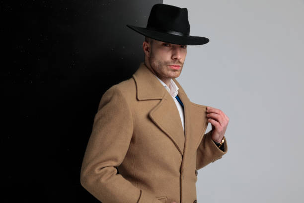 istock attractive young fashion model in long coat holding collar 1248488343