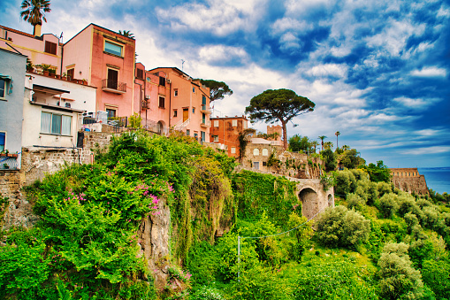 Looking at houses along the cliffside of the small village of Vico Equense.