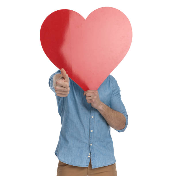 istock happy young guy covering face with big red heart 1248489678