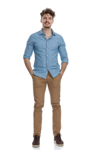 istock attractive casual guy in denim shirt holding hands in pockets 1248490983
