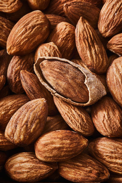 istock Close-up of open Almonds in a group and one into the shell 1248490995