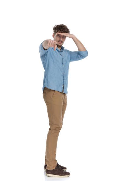 istock casual man holding hand to forehead and pointing finger 1248492916