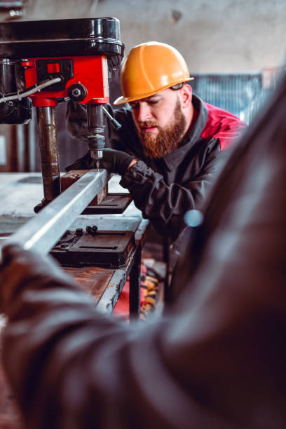 istock Worker Focusing On Drilling Metal Bar 1248493055