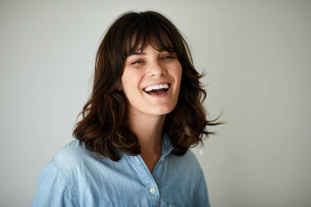 istock Young brunette woman laughing while relaxing at home 1248493143