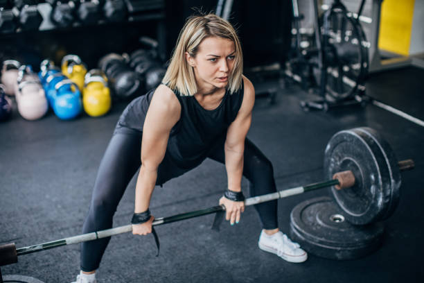 istock Strong woman exercising with weights in gym 1248495131