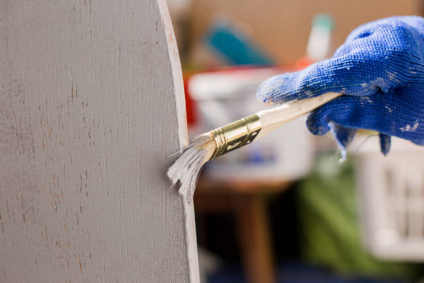 istock painter paints a tree with a brush with a glove 1248499907