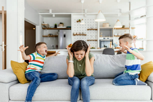 istock Unhappy mother having problem with noisy naughty two kids 1248500168