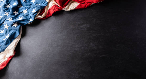 istock Happy Independence Day. American flags against a black  background. July 4. 1248500280