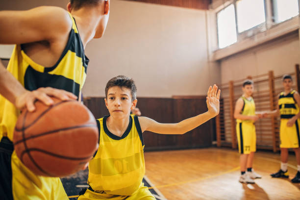 istock Young boys basketball players playing a match 1248501716