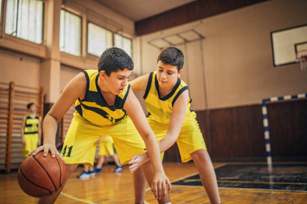 istock Young boys basketball players playing a match 1248501751
