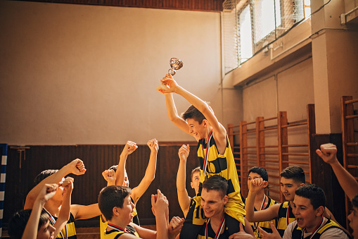 Young basketball team, teenage boys, wining first place in the mini basketball league.