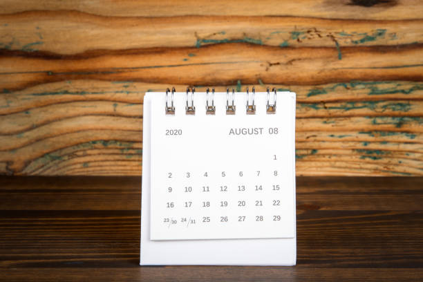 istock 2020 AUGUST. White paper calendar on a wooden table. Time planning 1248502294
