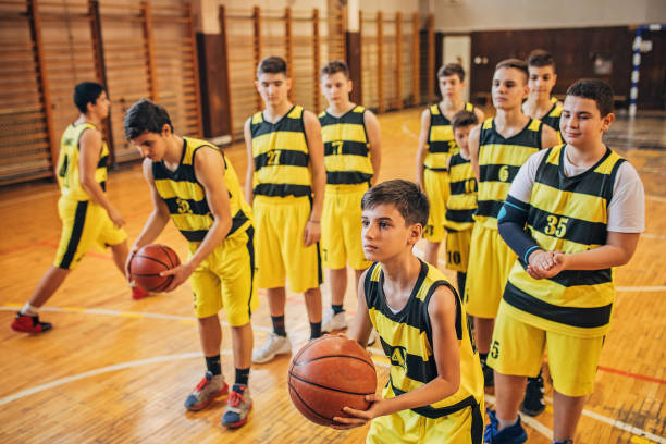 istock Teenage boys basketball players practicing a free throws 1248502936