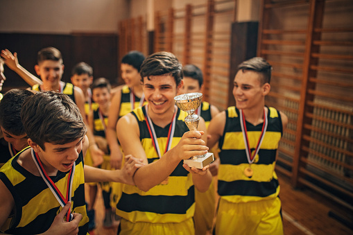 Young basketball team, teenage boys, wining first place in the mini basketball league.