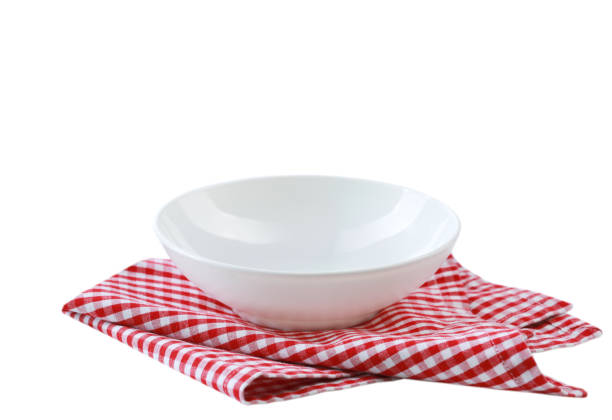 White bowl on red checkered cloth folded towel isolated.Food advertisement display.