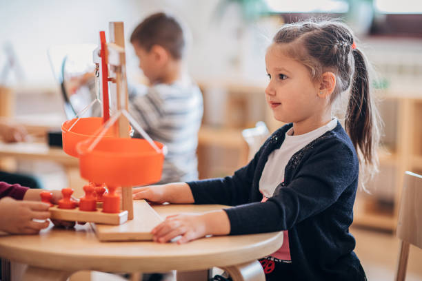 istock Preschool age girl playing with scale in classroom 1248512077