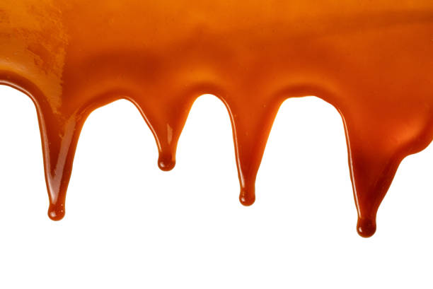 istock Background of flowing caramel sauce isolated on white. 1248512636