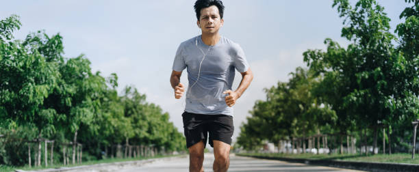 istock Young asian man running outdoors 1248514098