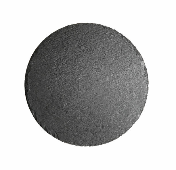 istock Round black slate dish plate isolated on white top view. 1248514725
