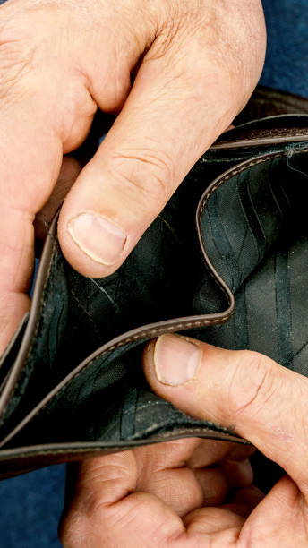 istock person wrinkled hands open empty black leather wallet macro 1248517092