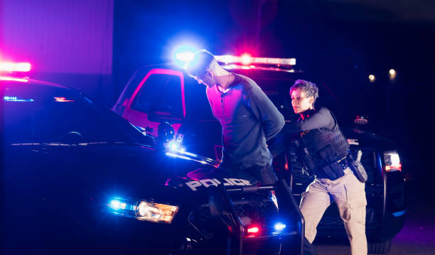istock Policewoman putting handcuffs on suspect 1248519512