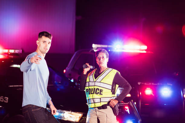 istock Policewoman at night talking with young man 1248520272