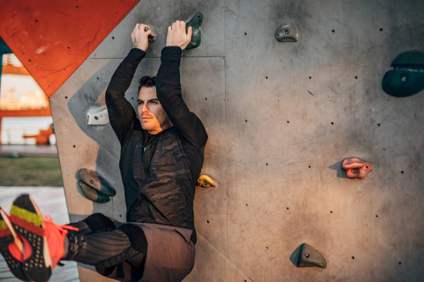 istock One sporty man doing push ups on climbing wall outdoors 1248520840