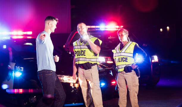 istock Police officers at night talking with young man 1248521454
