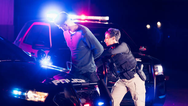 istock Policewoman putting handcuffs on suspect 1248521495