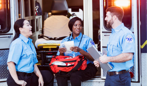 istock Paramedics conversing at the rear doors of an ambulance 1248521925