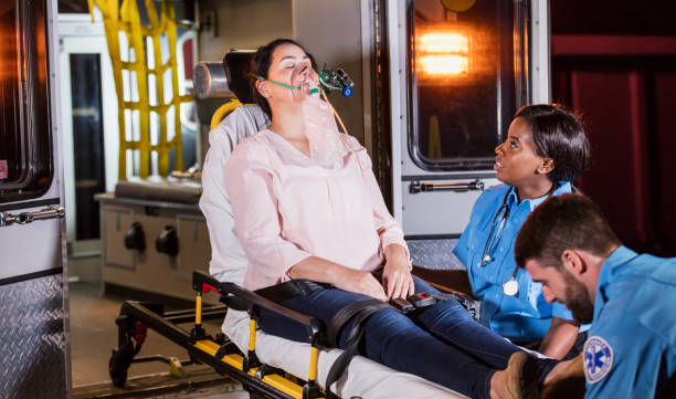istock Paramedics loading woman on stretcher into ambulance 1248522415