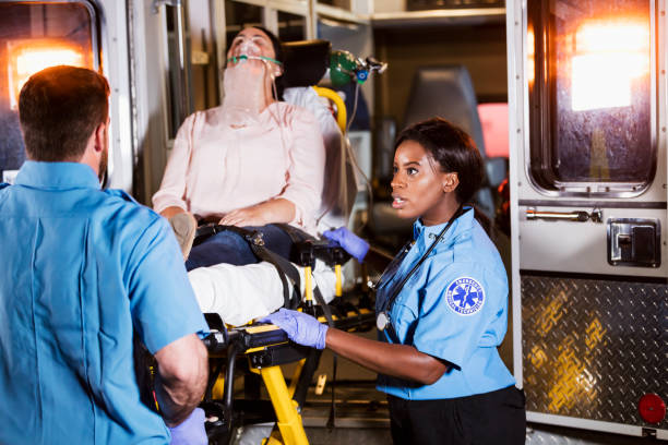 istock Paramedics loading woman on stretcher into ambulance 1248522586