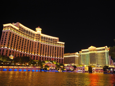 Las Vegas, United States - November 23, 2022: A picture of the Venetian Las Vegas at night, with the Rialto Bridge and the Campanile Tower on the left, Saint Mark and Saint Theodore columns on the right, and the Mirage on the far right.