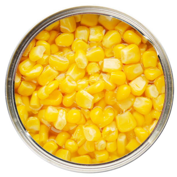 istock Flat lay view at opened tin can with sweet corns isolated on white background 1248524480