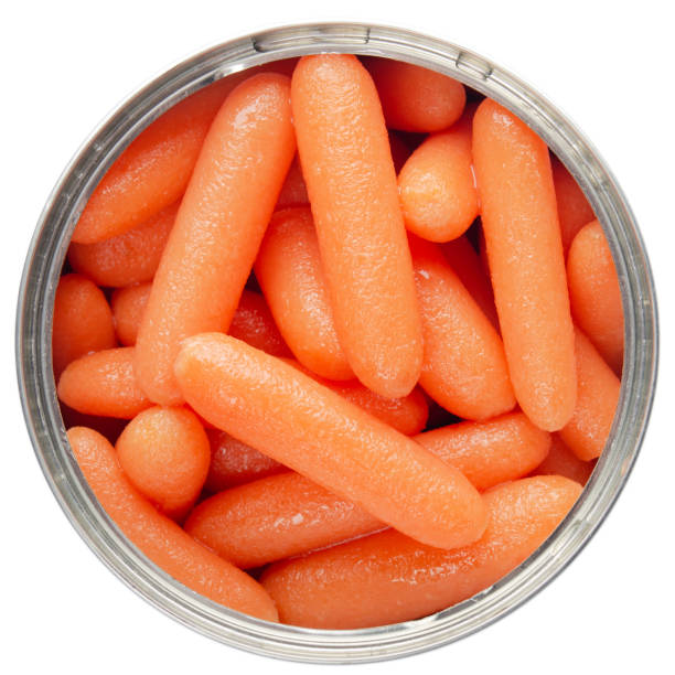 istock Flat lay view at opened tin can with carrots isolated on white background 1248524558