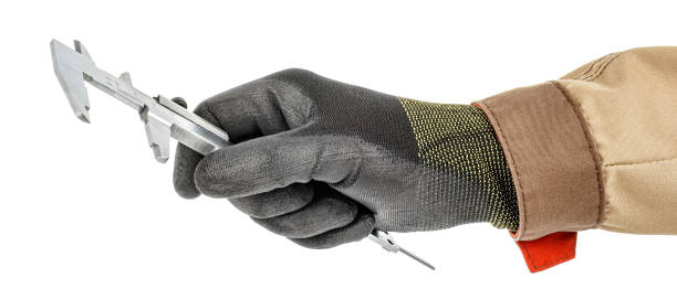 istock Man hand in black protective glove and brown uniform with vernier caliper isolated on white background 1248524594