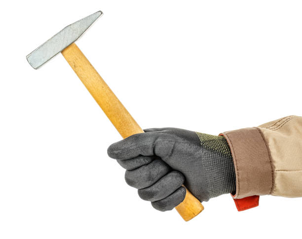 istock Classical metal hammer with wooden handle in worker hand in black protective glove and brown uniform isolated on white background 1248524607