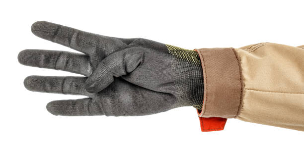 istock Man hand in black protective glove and brown uniform doing number four gesture isolated on white background 1248524621