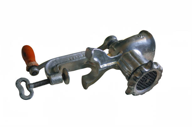 istock Old mechanical manual meat grinder isolate on a white background close-up. 1248525954