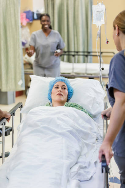 istock Nurse rolling patient on hospital gurney 1248526611