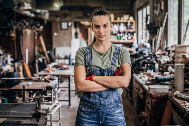 istock Young woman manual worker standing in workshop 1248526636