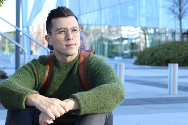 Thoughtful young ethnic man looking away