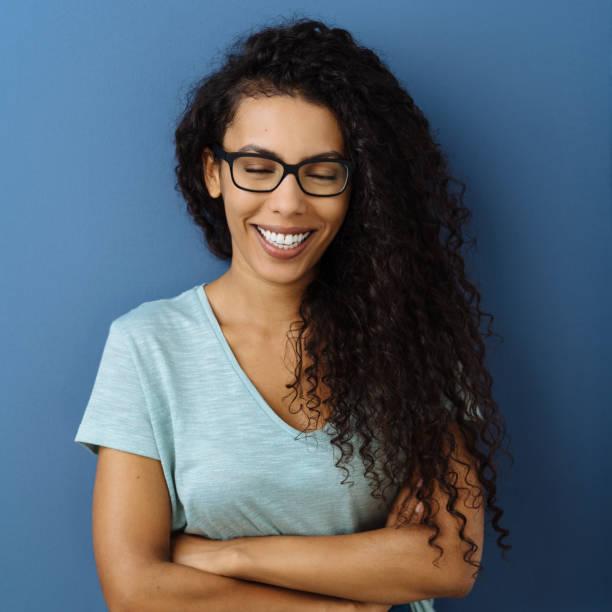 istock Happy young woman laughing with closed eyes 1248528627