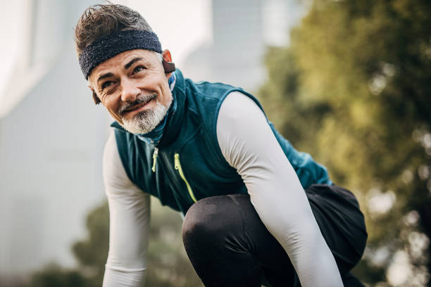 istock Mature man at starting position ready to start running 1248529886