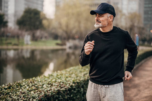 istock Handsome mature man jogging in public park 1248530804