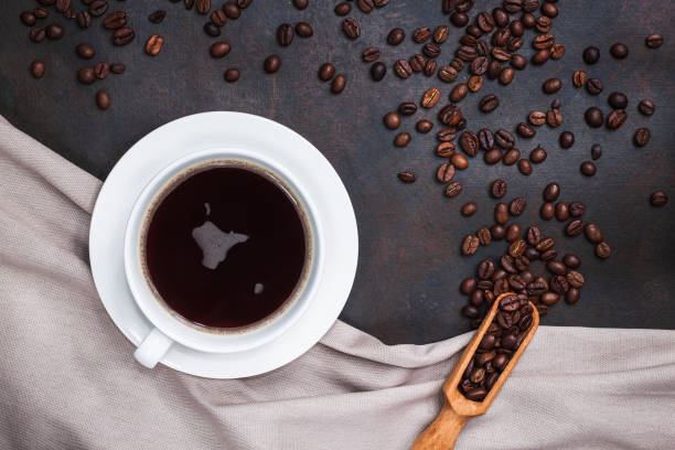 istock Coffee cup and coffee beans on dark table 1248530967