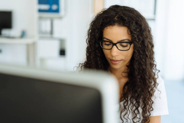 istock Serious young businesswoman concentrating 1248531165