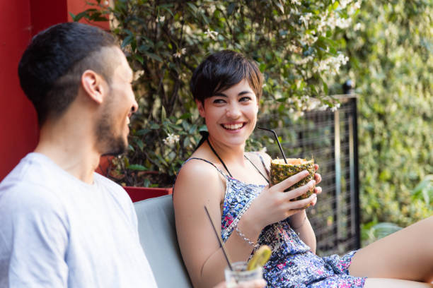 istock Couple drinking cocktails outdoors 1248531582