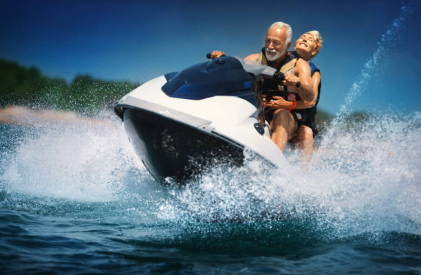 senior couple jet skiing. - nautical vessel motorboating motorboat fun imagens e fotografias de stock